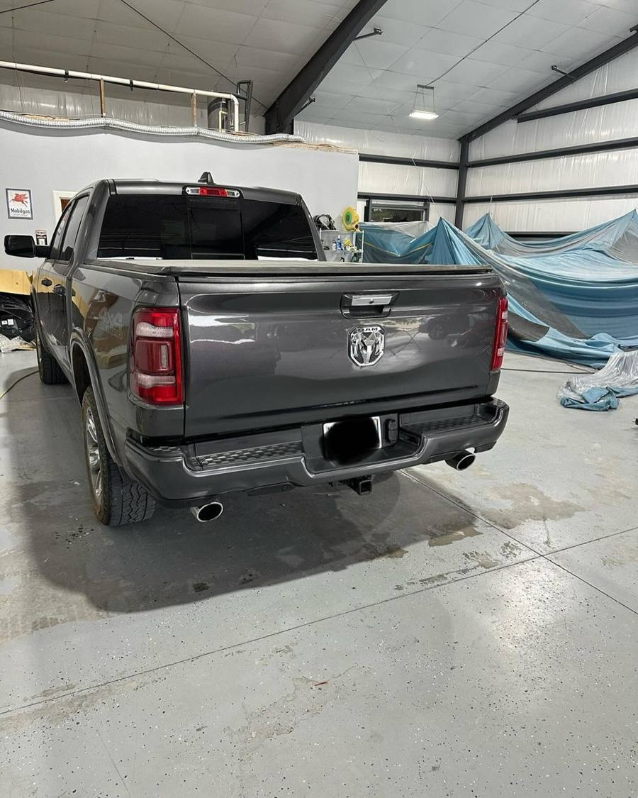 The same Ram 1500 after repair, with a new rear bumper and a straight tailgate