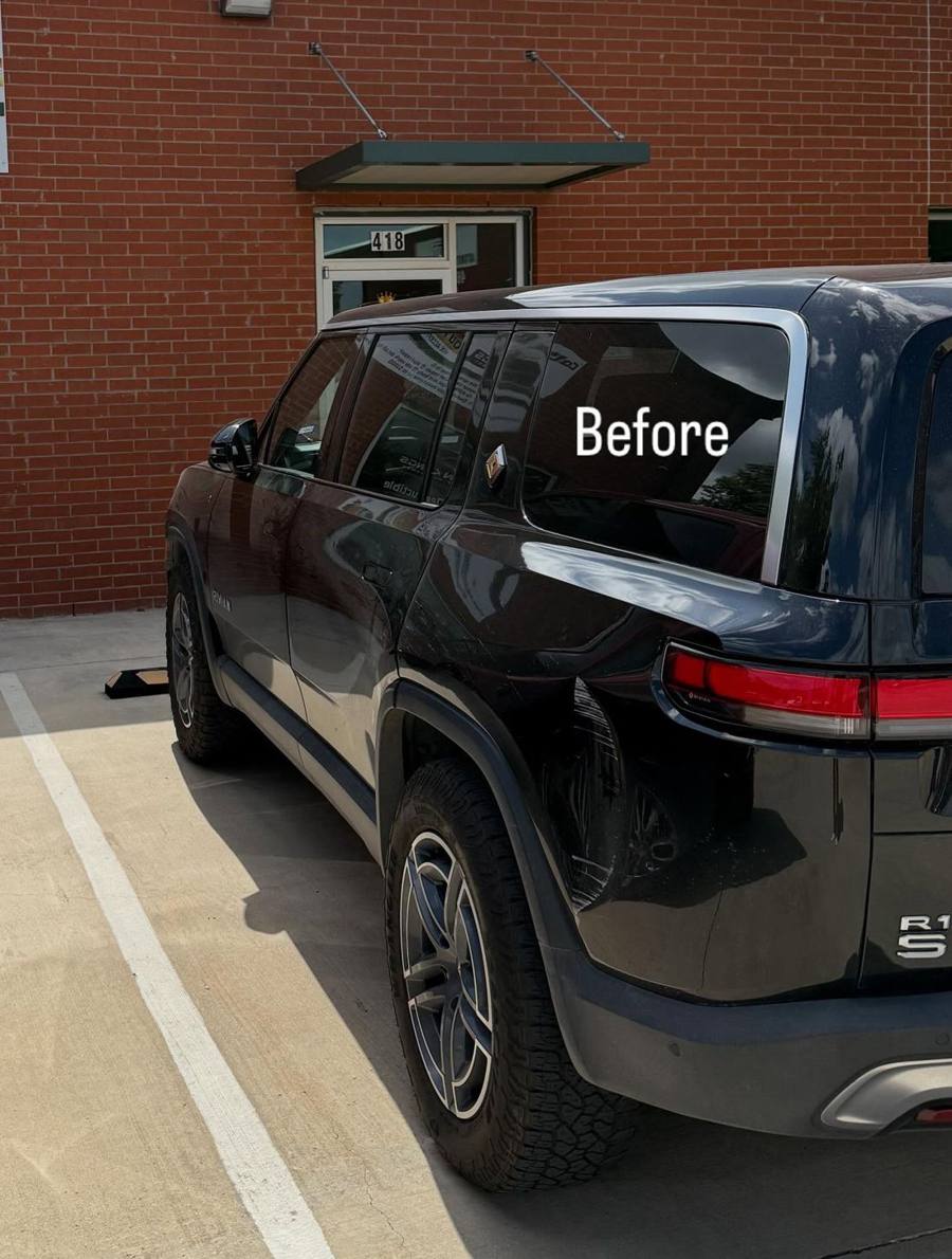 Black Rivian R1S with a scraped and dented rear quarter panel, before repair